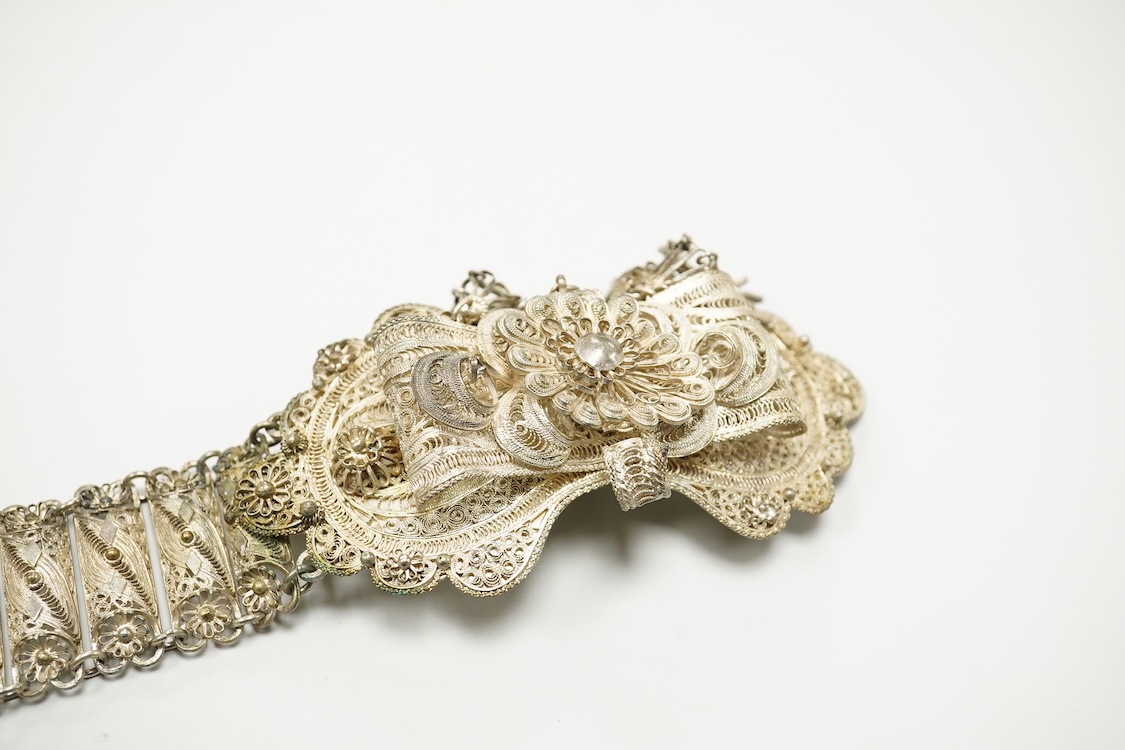 An Indian white metal filigree belt, 86cm.